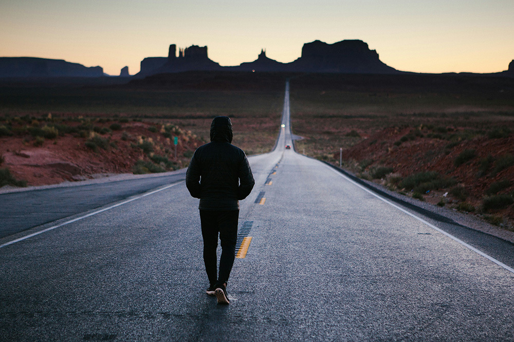 Motivated person walking a long highway