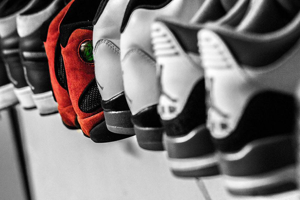 A selection of sports shoes with a uniquely colored pair indicating how autonomy in a program could motivate manager participation